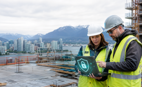 Construction managers reviewing cybersecurity on a Vancouver jobsite