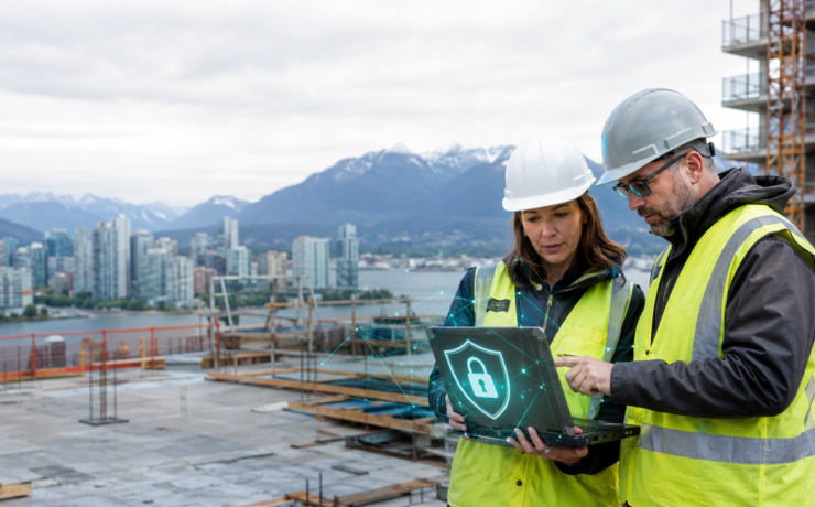 Construction managers reviewing cybersecurity on a Vancouver jobsite